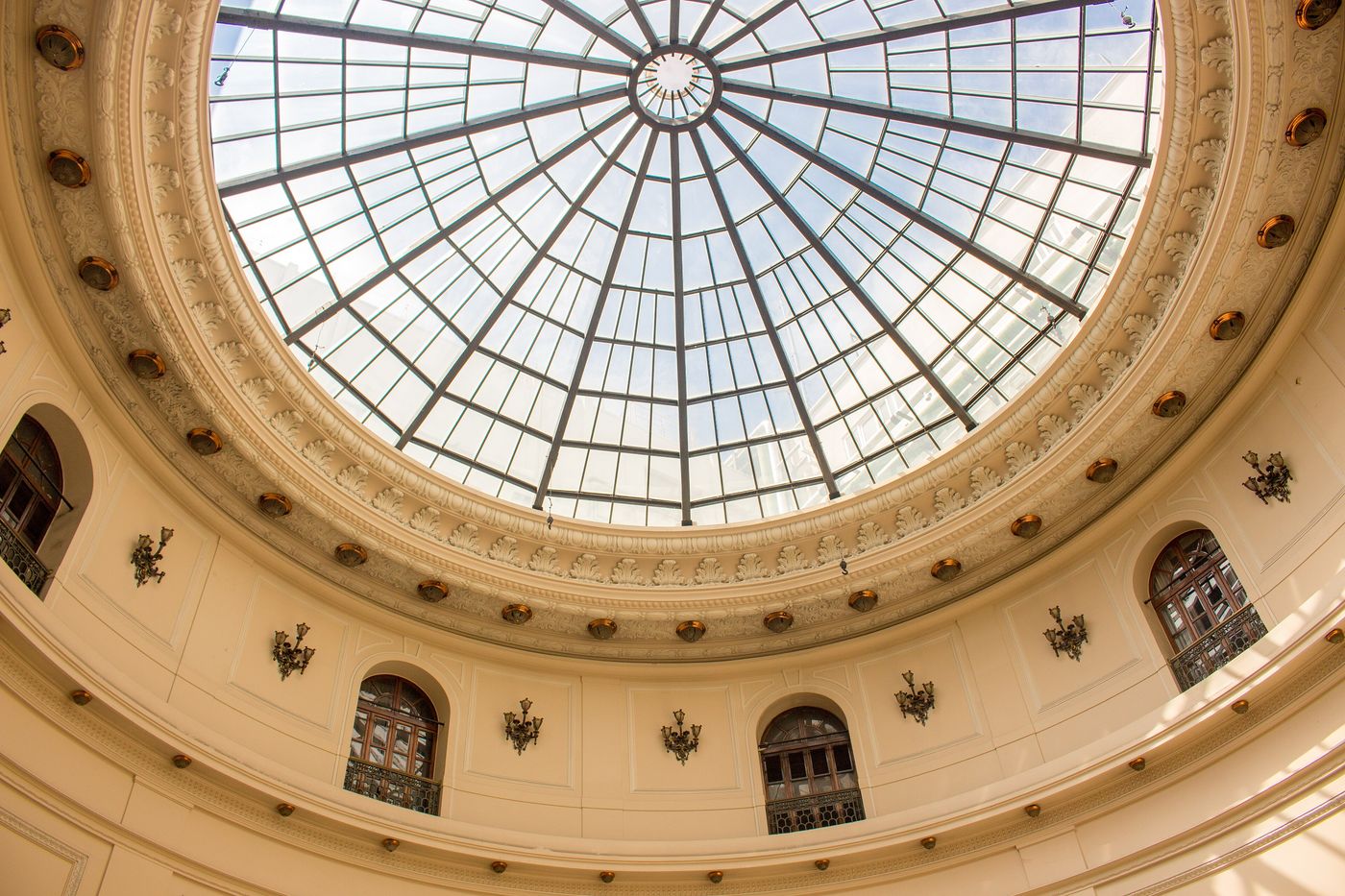 Looking up into the domed rotunda of the Centro Cultural Banco do Brasil, with a glass skylight and arched windows