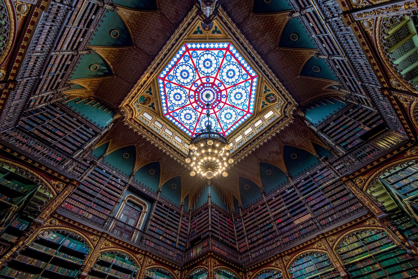 The stained-glass skylight and chandelier above the reading room of the Real Gabinete Português de Leitura